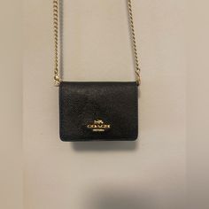 Please Read: Brand New Coach Wallet (Black) On A Gold Chain. You Will Receive The One That Is Brand New And Wrapped Up! The One Shown Is The Exact Same Thing But My Personal One That I Have Been Using! (I Had Ordered Two, One For Someone Else But I Did Not Give It To Them) Perfect For A Night Out Or Traveling With Small Baggage. Hard At Least 4 Cards, A Small Chapstick Or Lipstick, And Some Money! Black Wallet With Chain For Everyday Use, Black Chain Wallet For Everyday Use, Black Wallets With Chain Strap, Black Wallets With Chain Strap For Everyday Use, Black Evening Wallets With Chain Strap, Coach Wallet On Chain For Everyday Use, Black Evening Wallet With Chain Strap, Elegant Gold Coach Coin Purse, Black Wallet On Chain For Everyday