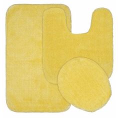 two yellow bathroom rugs with circles on the bottom and one circle in the middle