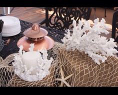 some white flowers sitting on top of a table next to burlocks and other items