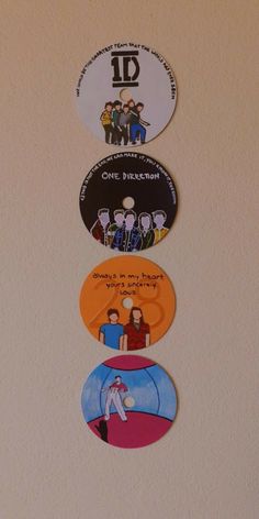 four different stickers on the side of a refrigerator door that say id, one direction, one direction