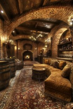 a living room filled with lots of furniture next to a brick wall covered in wine bottles