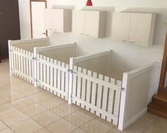 an unfinished kitchen with white cabinets and cupboards on the wall, in front of a tiled floor