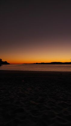 an orange and yellow sunset at the beach