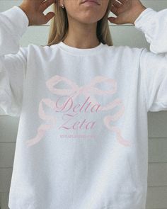 tied together with a bow <3 ♡ Super soft sweatshirt comes in unisex sizing! Reference the size chart for additional details. It is recommended to SIZE UP for an oversized fit   ♡ Sweatshirt comes in white with a light pink print. Please check listing photos for color reference! ♡ Please make sure you are ordering for the correct sorority before placing an order! This listing is for DELTA ZETA. We are unable to accept returns or exchanges for this since all items are made to order.   ♡ INSTRUCTIONS FOR CARE:  1. Turn inside out before washing  2. Wash on a gentle cycle  3. Recommended not heat dry to prevent any minimal shrinking, hang to dry instead ♡ It is important that you LOVE your product! If you have any questions or concerns upon receiving your product, please contact me immediately White Sorority Crew Neck Sweatshirt, White Crew Neck Sorority Sweatshirt, Cotton Sweatshirt With Graphic Print For Sorority, Cotton Sorority Sweatshirt With Graphic Print, Sorority Long Sleeve Graphic Sweatshirt, Sorority Graphic Print Long Sleeve Sweatshirt, Zeta Tau Alpha Sweatshirt, Delta Zeta Merch, Delta Zeta Graphics