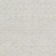 a white rug with an abstract design on the front and back side, in shades of beige