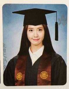 a young woman wearing a graduation cap and gown