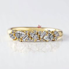 a yellow gold wedding band with five pear shaped diamonds