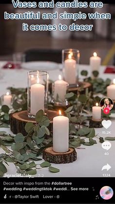 the table is set with candles and greenery