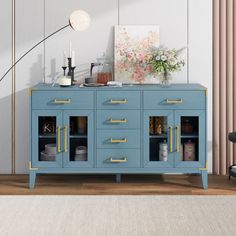 a blue cabinet with gold handles and drawers