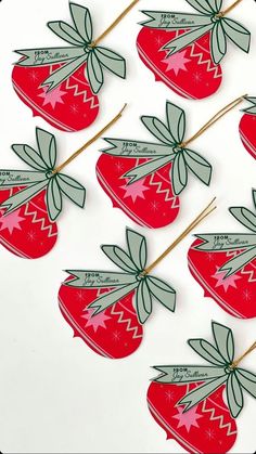 strawberries are arranged on sticks with bows