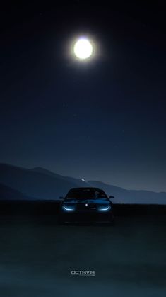 a car is parked in the middle of an empty field at night