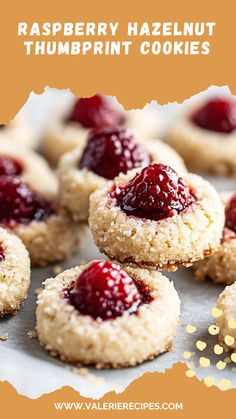 raspberry hazelnut thumbprint cookies on a baking sheet