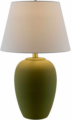 a green lamp with a white shade on it