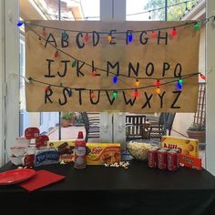 a table topped with a sign and lots of food