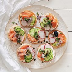 a white plate topped with cucumbers and smoked salmon