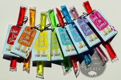 there are many different colored candy sticks with tags on them that say have cool summer