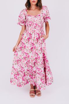 Stay light-hearted and lovely in the Rosy Outlook Dress. This tiered maxi length dress boasts a playful sweetheart neckline, puff sleeves, and a flirty ruffle on the shoulders. The floral pattern in shades of pink and green on a white background will have you feeling positively blooming. Details Smocked bodice Tiered Floral pattern with shades of pink and green on a white background Slight puff sleeve with elastic Ruffle on shoulders of neckline Sweetheart neckline Maxi length Lined on chest down & skirt down to knee length Sizing *This style has stretch beyond measurements through the bust.* Approximate measurements: SIZE LENGTH BUST Small 51" 30" Medium 52" 32" Large 53" 34" Fabric has stretch in the bodice Model is 5’8 wearing small Material Self: 100% CottonLining: 100% PolyesterHand w Shades Of Pink, Sweetheart Neckline, Puff Sleeves, Pink And Green, Dresses For Sale, Smocking, Dress Length, Puff Sleeve, White Background