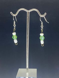 Light green pearl with white beads dangling  Earrings Green Pearl Earrings As Gift, White Crystal Drop Earrings With Ear Wire, White Pearl Beaded Drop Earrings, White Pearl Earrings With Ear Wire, White Pearl Drop Beaded Earrings, White Pearl Earrings With Round Beads, Green Pearl Drop Earrings As Gift, Adjustable White Beaded Pearl Earrings, Elegant Light Green Earrings For Gift