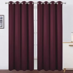 the curtain is open and ready to be hung in front of a window with dark red curtains