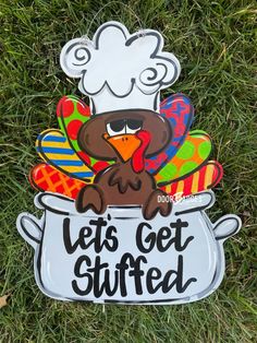 a sign that says let's get stuffed in the grass