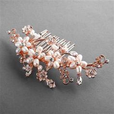 Rose Gold Plated Pearl Hair Comb This freshwater pearl bridal hair comb will add a beautiful touch of rose gold to your wedding day hairstyle. This hand-wired wedding comb features a beautiful floral design with freshwater pearls and crystals. This beautiful headpiece will be the perfect accessory to complete your bridal look. Size: 4 1/2" long and 2 1/4" wide. Color: Rose Gold/Ivory. Style:4388HC. Please allow 1 week for U.S. delivery. Shipping Policy. Return Policy Silver Wedding Headpiece, Pearl Bridal Comb, Bridal Hair Combs Pearl, Bridal Roses, Rose Gold Crystal, Rose Gold Bridal, Bridal Comb, Pearl Bridal, Hair Comb Wedding