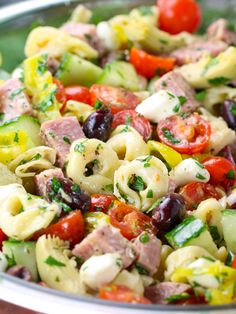 pasta salad with tomatoes and olives in a bowl