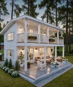 a large white house sitting on top of a lush green field