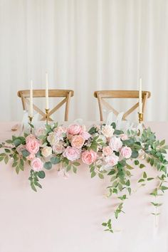 the table is set with flowers and candles