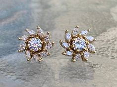 Metal: 14k Yellow Gold Stones: Diamonds (2) Two Diamond Studs Cut: Round Brilliants Color: I Colors Clarity: SI1 Carat: .75 carats total weight (2) Two Diamond Earring Jackets: Each Jacket Contains (9) Nine Diamonds Cut: Marquis Cuts Color: I Colors Clarity: SI2 Carat: Approximately 1.50 carats total weight These beautiful diamond stud earrings can be worn alone... or if you would like to dress them up, the stunning marquis diamond jackets complement and enhance the look. They are handmade and l Diamond Jacket Earrings, Marquis Diamond, Diamond Earring Jackets, Cluster Earring, Marquise Earrings, Light Jewelry, Diamond Cluster Earrings, Earring Jackets, Solitaire Earrings