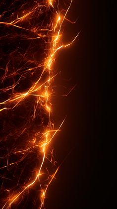 an orange and yellow fire sparkles against a black background with light streaks on it