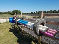 there are many different colored hoses on the fence