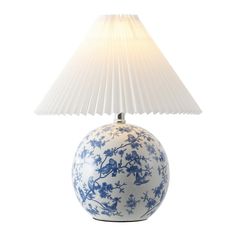 a blue and white vase with a lamp on it