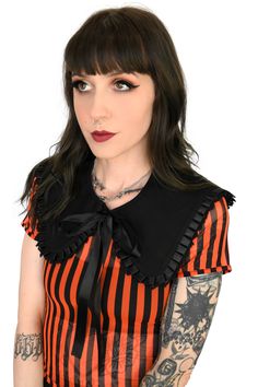 We will be pairing this with literally everything from here on out. Inspired by our sister store My Violet's Dolly collar! This all black detachable collar is made to be worn over anything! Shown here on our All Bones Orange Cardigan and Zeebo Mesh Top. Cute black ribbon trim and front tie bow. Available in 2 sizesSize 1 - 16 inches neck circumferenceSize 2 - 19 inches neck circumference Models wearing size 1 Cotton with polyester trim. Part of the FOXBLOOD Signature Collection, designed by us i Gothic Black Top With Lace Collar, Black Fitted Top With Peter Pan Collar, Black Fitted Top With Doll Collar, Mesh Bolero, Claudia Black, Orange Cardigan, Detachable Collar, Orange Sweaters, Gorgeous Clothes