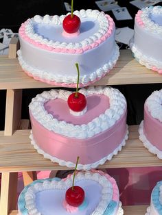 several heart shaped cakes with cherries on top