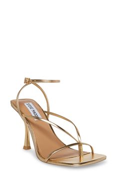 Add an extra touch of polish to your special-occasion style with this strappy sandal lifted by an elegant stiletto heel. 3 3/4" heel (size 8.5) Adjustable ankle strap with buckle closure; hidden elastic inset Synthetic upper, lining and sole Made in Brazil Gold Sandals With Wrapped Heel For Date Night, Gold Sandals With Padded Heel For Date Night, Glamorous Strappy Sandals With Wrapped Heel, Chic Gold Ankle Wrap Sandals, Gold Strappy Heels With Heel Strap, Gold Chic Ankle-wrap Heels, Chic Gold Ankle Wrap Heels, Elegant Gold Ankle Wrap Sandals, Formal Heels With Padded Heel And Ankle Wrap