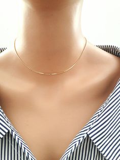 "Handmade by Eriko Design Studio in Brooklyn, NY Delicate gold snake chain choker necklace- basic yet stylish: it can be layered with other chokers or necklaces. -------------------- DETAILS ・1 mm 24K gold plated snake chain ------------------- SIZE ・Available in 4 sizes 12\"- 14\" ( 12 inches + adjustable 2 inch extender) 14\" -16 \"( 14 inches + adjustable 2 inch extender) 16\"- 18\"( 16 inches + adjustable 2 inch extender) 18\"-20\"(18 inches + adjustable 2 inch extender) ・It closes with lobs Unique Choker Necklaces, Choker Necklace Gold, Dainty Chain Necklace, Gold Snake Chain, Gold Chain Choker, Dainty Chain, Necklace Simple, Gold Choker Necklace, Plastic Jewelry