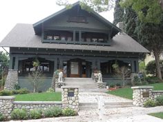 a large house with lots of windows and stone steps leading up to the front door