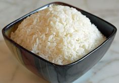 a bowl filled with rice on top of a table