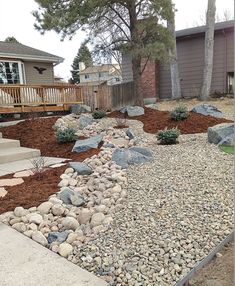 a rock garden bed in front of a house