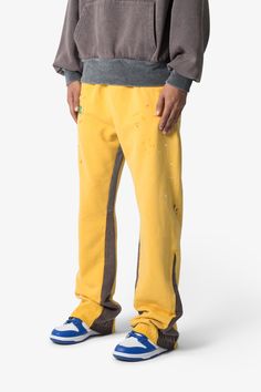 the Contrast Bootcut Sweatpants are designed with a relaxed fit throughout, featuring an elasticized self waist and leg opening, multi-colored paint splatter throughout, and finished with denim and contrasting panels at the inseam and outseam to provide a flare at the leg opening. details relaxed fit flared leg opening 100% cotton model is 6’1, 140 lbs and wears a size medium Yellow Sweatpants With Pockets For Loungewear, Bootcut Sweatpants, Sporty Yellow Sweatpants For Streetwear, Yellow Sporty Yoga Bottoms, Yellow Urban Streetwear Bottoms, Yellow Sweatpants With Pockets For Streetwear, 140 Lbs, Denim Patchwork, Mohair Sweater