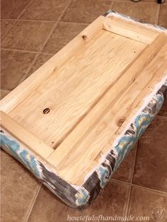 a piece of wood sitting on top of a tiled floor