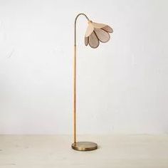 a lamp that is on top of a table next to a vase and potted plant