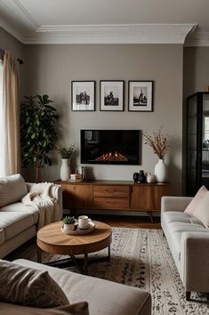 a living room with two couches and a coffee table in front of a fireplace