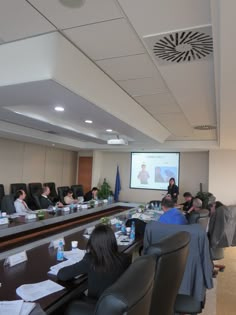 a group of people sitting around a conference table