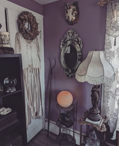 there are two lamps and a mirror on the wall in this room with purple walls