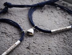 two personalized bracelets with silver beads on a blue cord that says love you