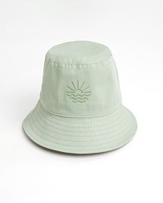 Sun, sea, and 100% cotton Nothing says cool and breezy like a bucket hat. It's snug, soft, and gives you that easy-going surfer dude look - all whiles shielding you from the sun! All our hats are 100% cotton, Sage Green in color, and embroidered with a sun and sea logo - letting you enjoy the seaside sun in style! Jojo bucket hat in Sage Green  Wider brims provide more protection from the UV lights 100% cotton gabardine Spot clean / cold hand wash Suitable for 55-58 cm Cotton Bucket Hat With Uv Protection For Vacation, Lightweight Cotton Summer Hats, Cotton Beach Bucket Hat With Short Brim, Cotton Bucket Hat With Short Brim For Beach, Cotton Bucket Hat For Beach Season, One Size, Cotton Bucket Hat For Beach Season, Solid Bucket Hat For Beach Season, Adjustable Cotton Bucket Hat For Beach Season, Solid Color Bucket Hat For Beach Season