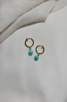 These dainty earrings are made with turquoise stones and gold or platinum plated huggie hoops. This plating protects against wear and tear, tarnishing, and light contact with substances such as water. Closures: * Standard gold hoops are hypoallergenic and nickel free (18 karat gold plated). * Standard silver hoops are hypoallergenic and nickel free (platinum plated). * Clip on gold hoops are hypoallergenic and nickel free (18 karat gold plated). * Clip on silver hoops are hypoallergenic and nick Turquoise Sterling Silver Huggie Jewelry, Turquoise Dangle Hoop Earrings For Gift, Turquoise Dangle Jewelry For Everyday, Turquoise Hoop Pierced Earrings, Turquoise Pierced Hoop Earrings, Minimalist Handmade Blue Hoop Earrings, Turquoise Hoop Earrings As A Gift, Blue Handmade Minimalist Hoop Earrings, Turquoise Hoop Earrings For Gift