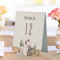 the table numbers are displayed in mason jars and vases with pink flowers on them