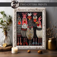 two roosters are standing next to each other in front of a white frame on a table